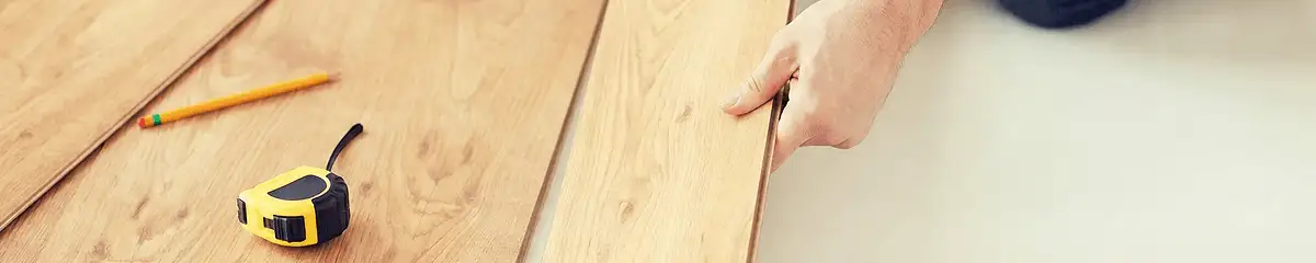 A professional installing wood flooring in Fargo, ND