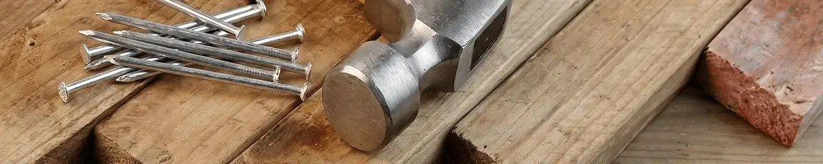 Hammer and nails on hardwood flooring boards in Fargo, ND