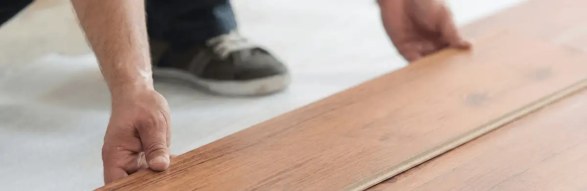 A professional installing laminate flooring in Fargo, ND