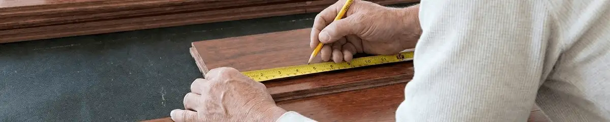 A professional installing wood flooring in Fargo, ND